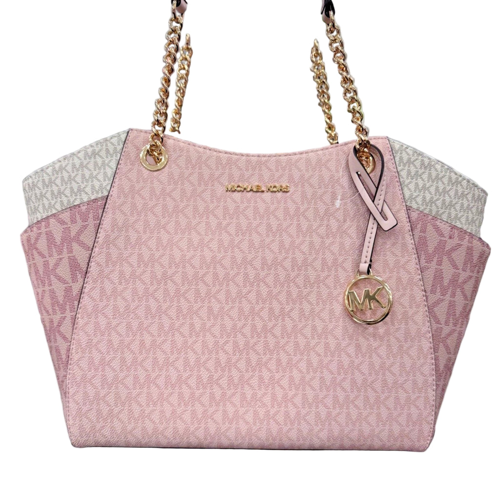 Pink handbag with gold chain strap and logo on a stand in a store setting